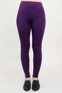 Front view of a person wearing plum bamboo leggings with black slip-on shoes