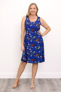 Front view of woman wearing a blue floral dress and sandals against a white background