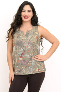 Woman posing with her hand on her hip wearing a sleeveless green tank top with neutral floral pattern