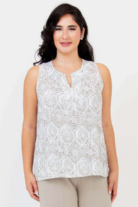Front view of model wearing sleeveless Scarlette split neck tank with subtle geometric pattern
