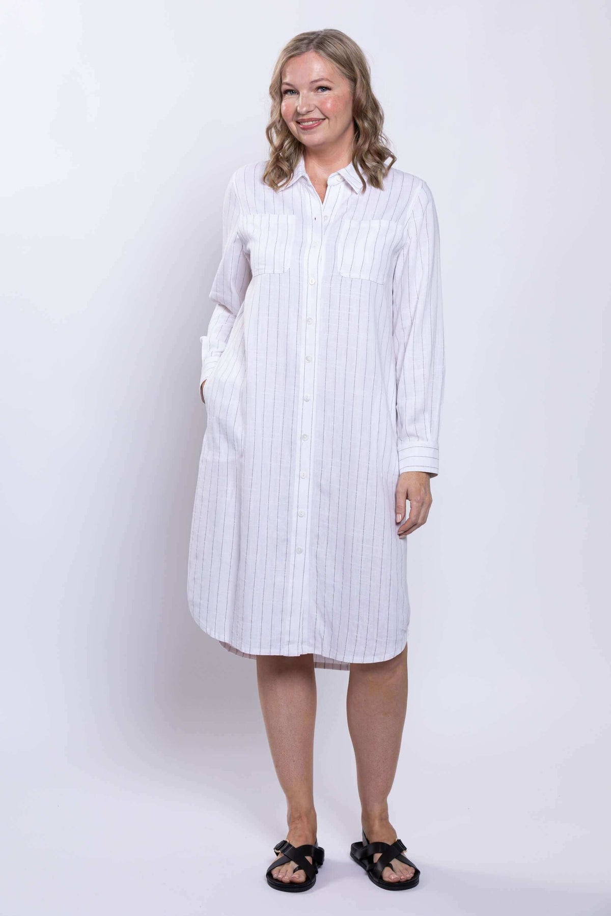 Side-angle front view of a model in a striped viscose linen long duster dress