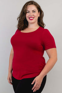 Woman in a crimson short sleeve bamboo tee, side angle