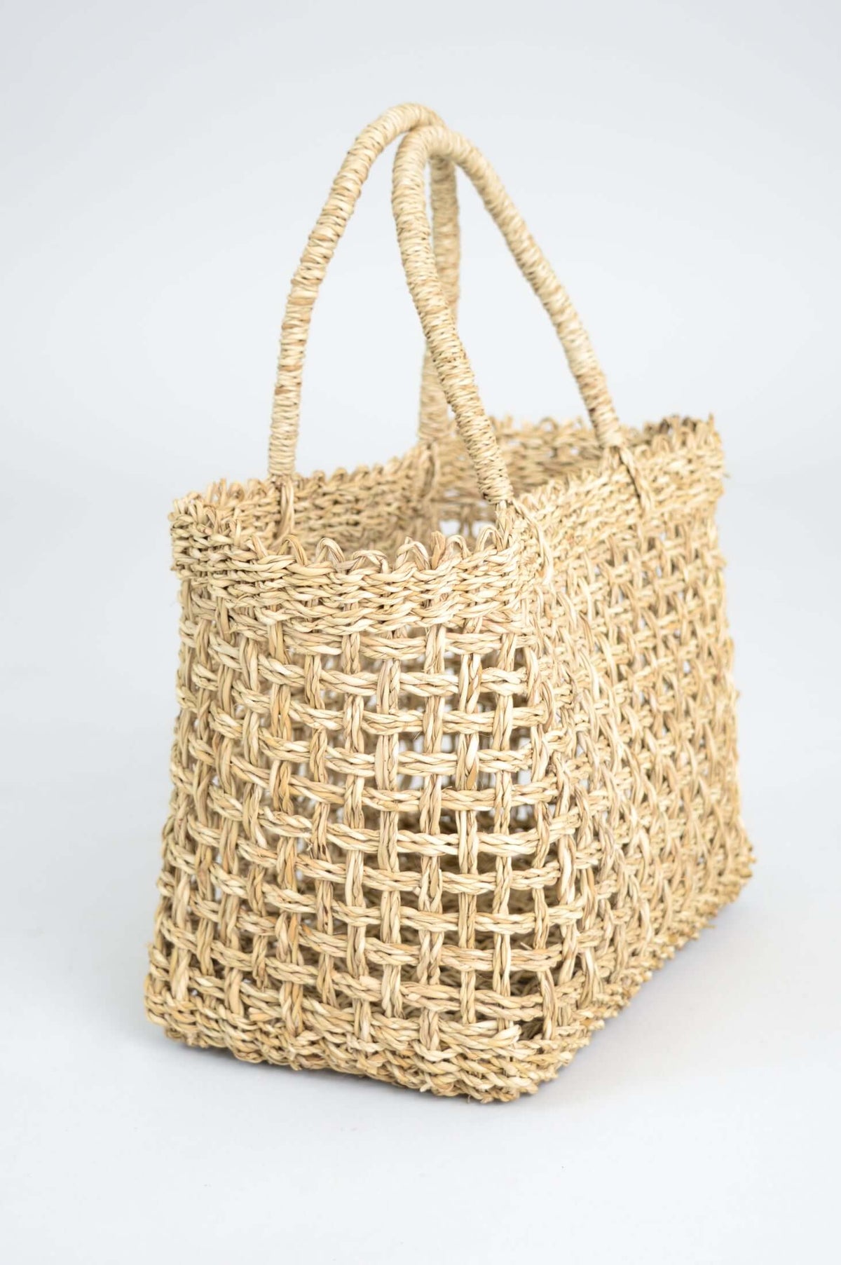 Side view of hand woven rattan basket highlighting its woven design