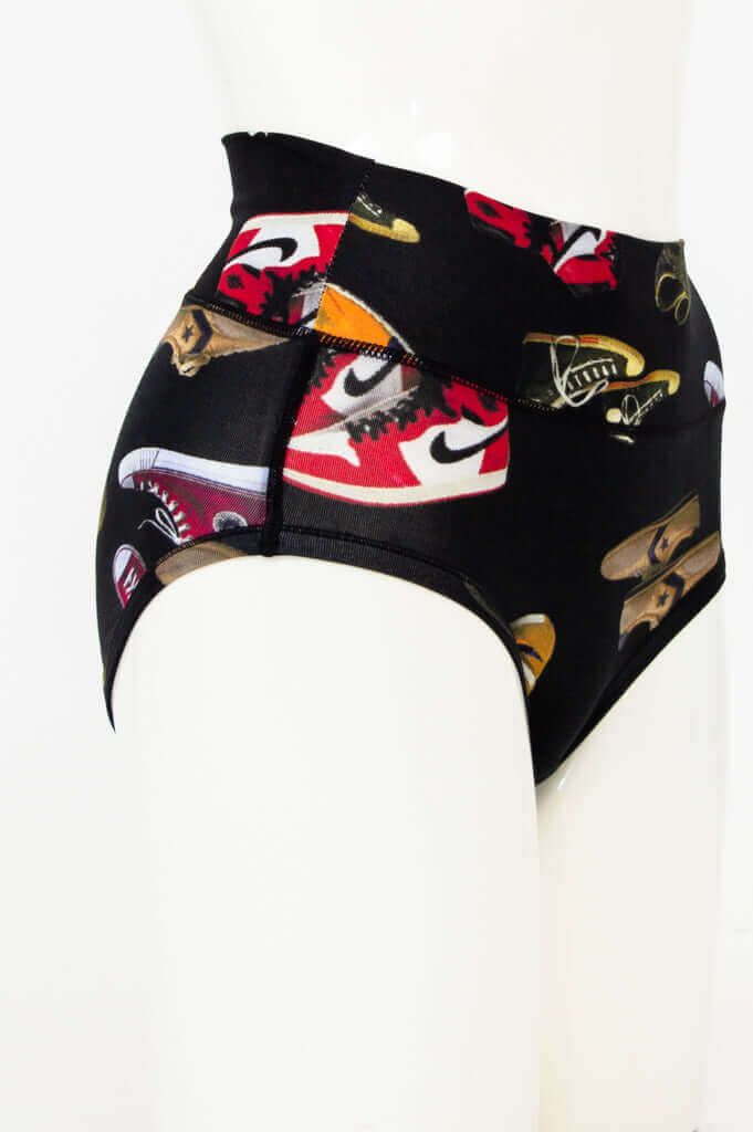 Side view of black brief featuring multiple sneaker designs