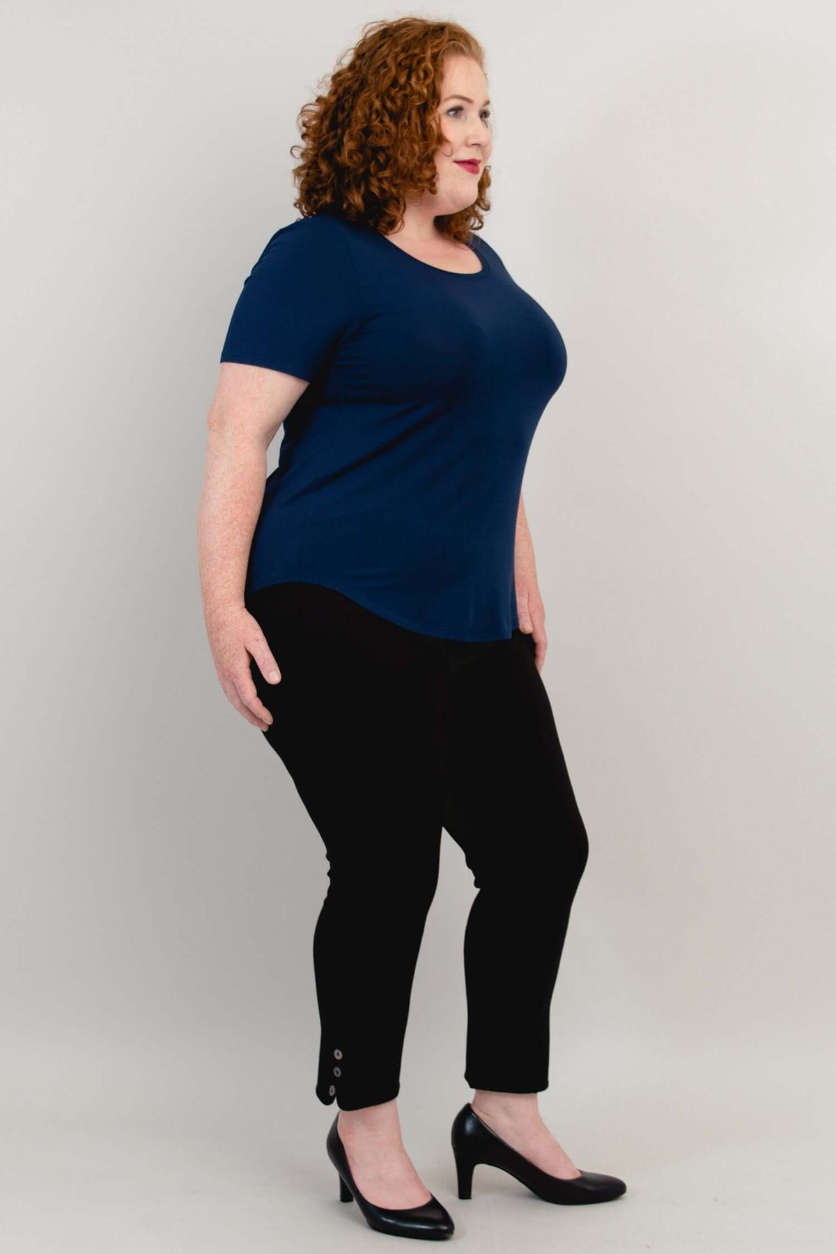 Profile view showing side fit of navy blue scoop neck tee