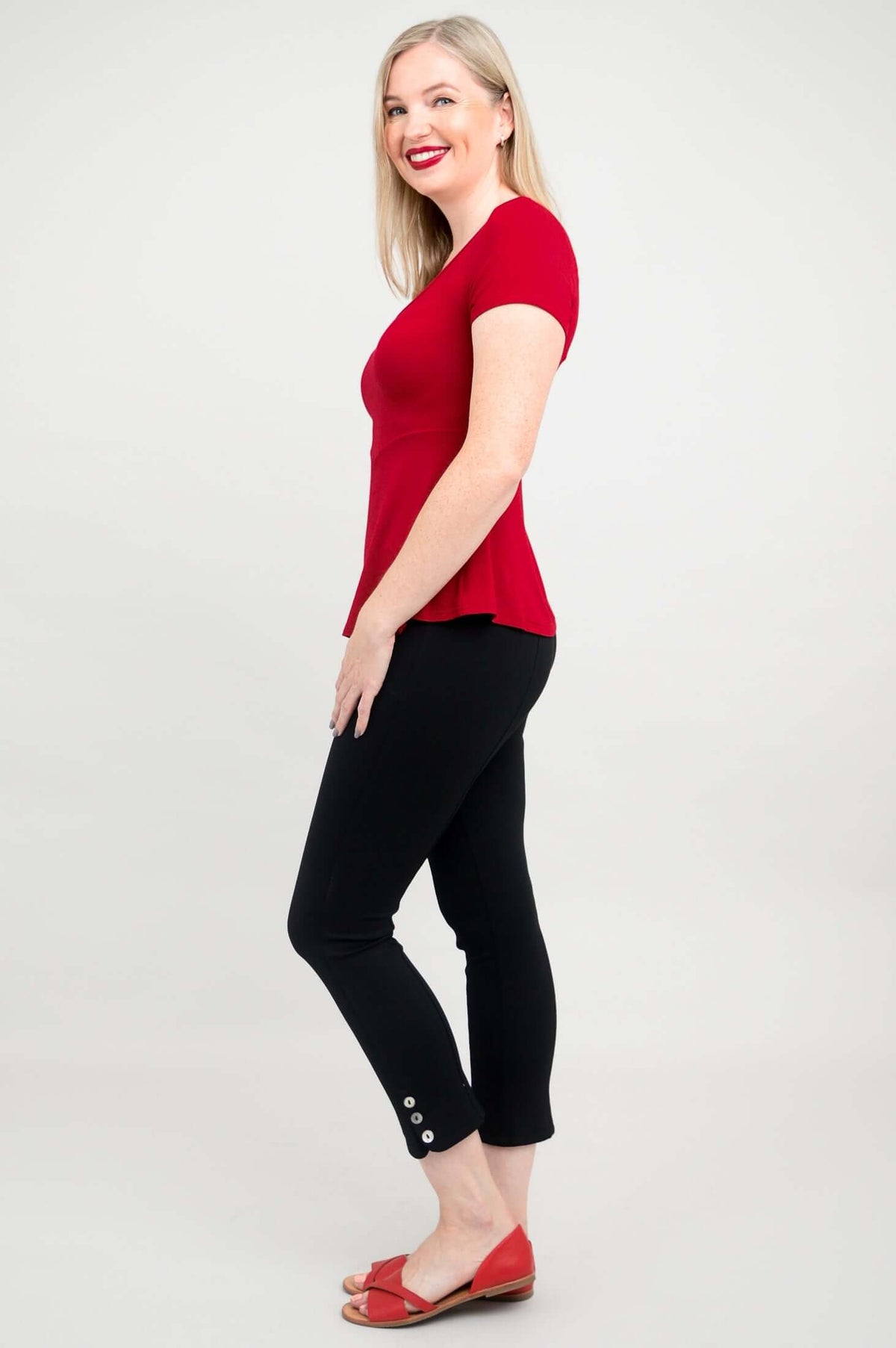 Side profile of woman wearing Kim Cap bamboo top in cherry red