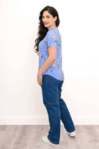 Side view of woman wearing blue floral print tee and jeans