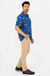 Side view of man in blue monster truck shirt and tan pants