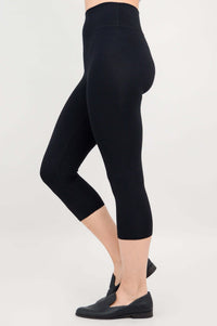 Side profile of model in black capri leggings displaying shape and fit