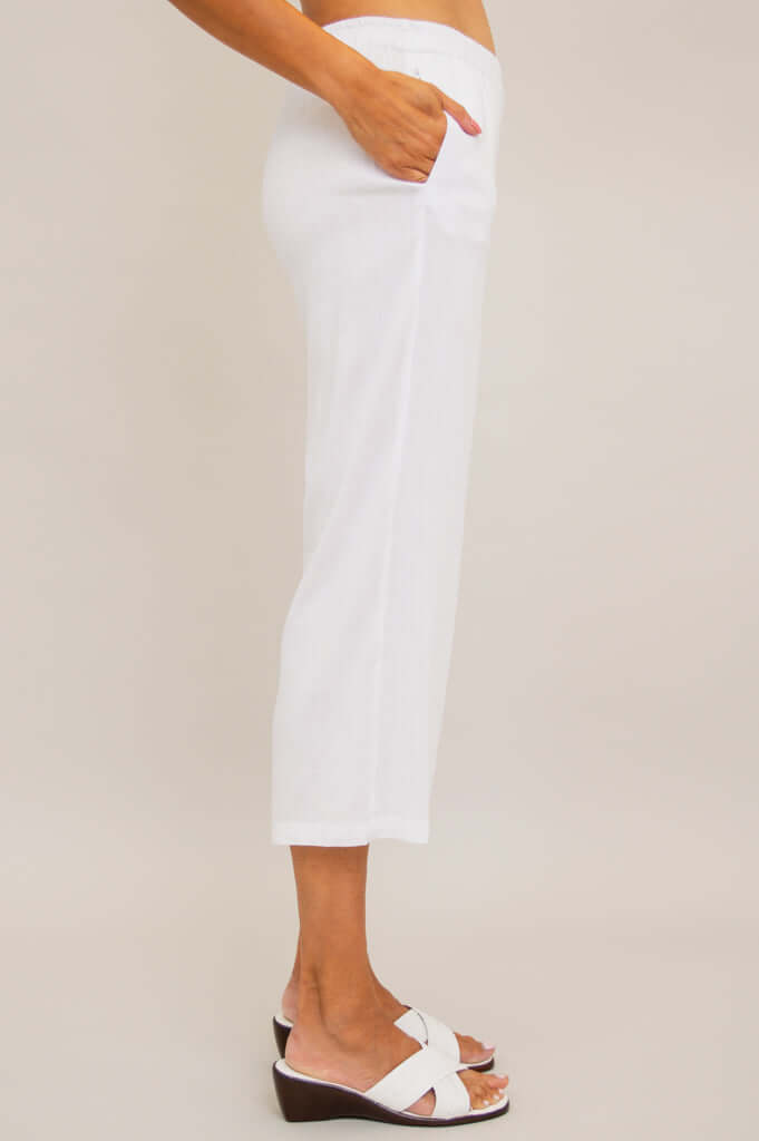 Side profile of Bella Capri Pant in white, displaying cropped length and pocket detail