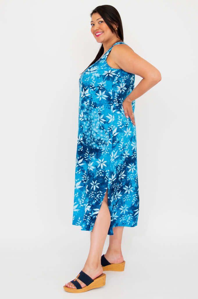 Model showing side view of blue floral dress with slit and square neckline