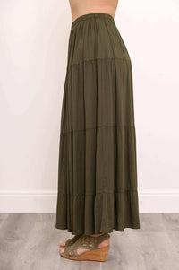 Side view of olive green tiered maxi skirt showing layered detailing
