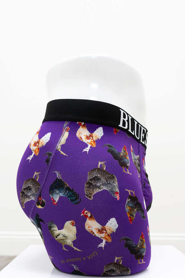 Side view of purple rooster print men's boxer briefs on mannequin