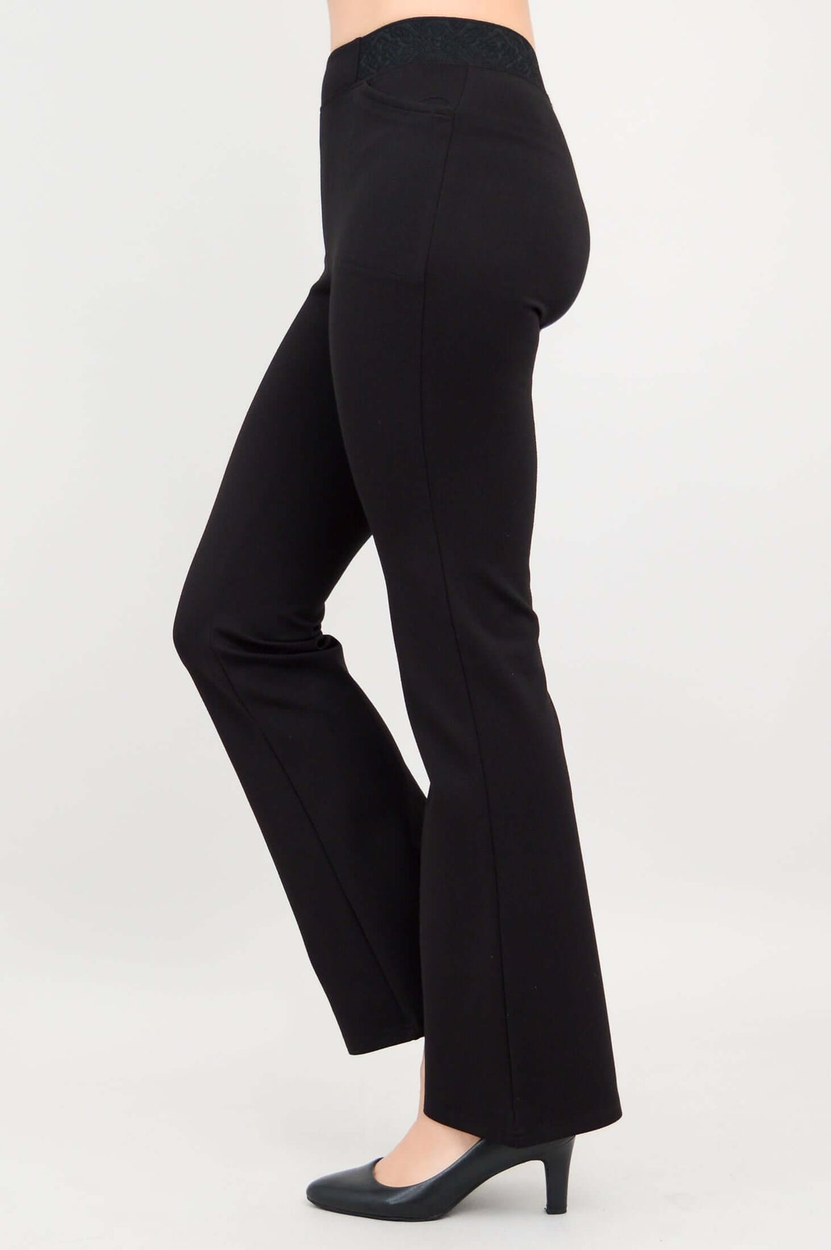 Side view showing the slim fit and flare design of black modal pants