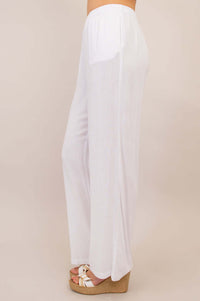 Side view of white linen-bamboo pants highlighting straight drape