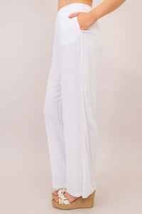 Side view of white wide leg linen-bamboo pants showing relaxed fit