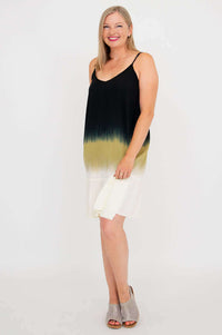 Side view of woman in ombre sleeveless dress holding the skirt slightly