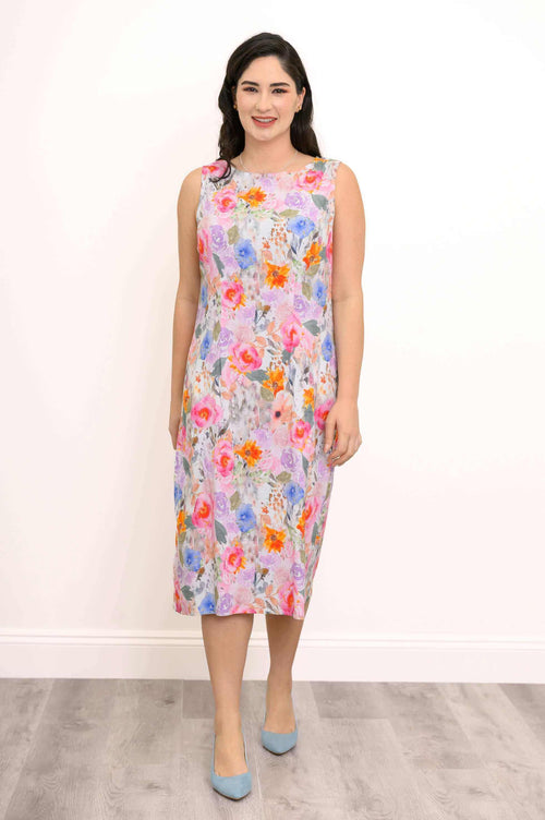 Woman wearing a sleeveless floral shift dress with a relaxed fit