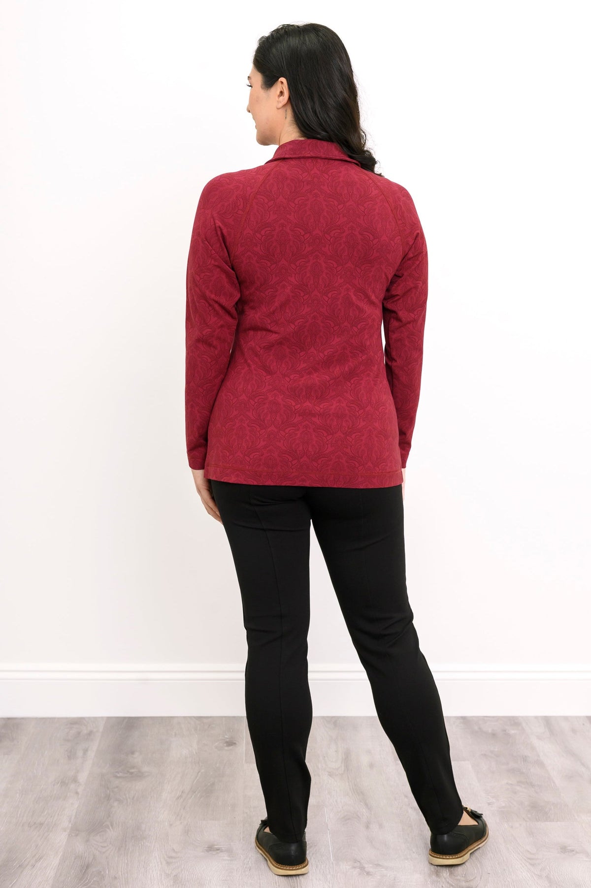Back view of a red patterned bamboo knit jacket, showcasing clean vertical seams and a straight back hemline.