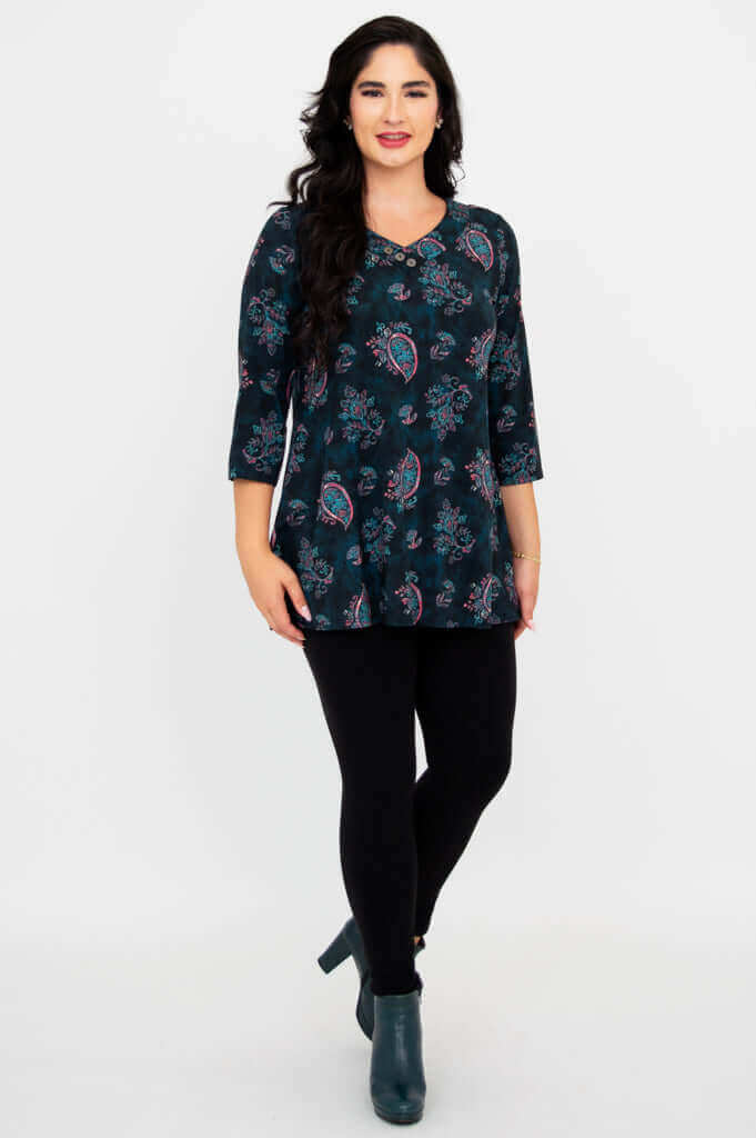 Front-facing standing model in Vana Tunic, paired with black leggings and boots