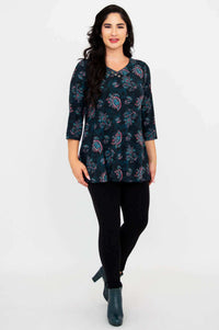 Front-facing standing model in Vana Tunic, paired with black leggings and boots