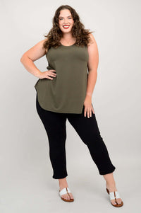 Plus-size model standing with one hand on hip in olive green bamboo tank