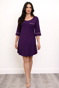 Full body view of woman modeling a purple sleep dress with pink trim