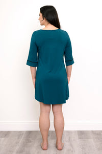 full body back view of woman wearing a teal colored nightgown with black trim