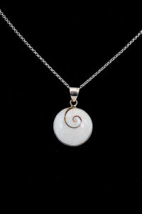 Sterling silver necklace with a round Shiva Eye pendant on a black background