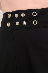 Close up of black skirt with grommet details at the waist