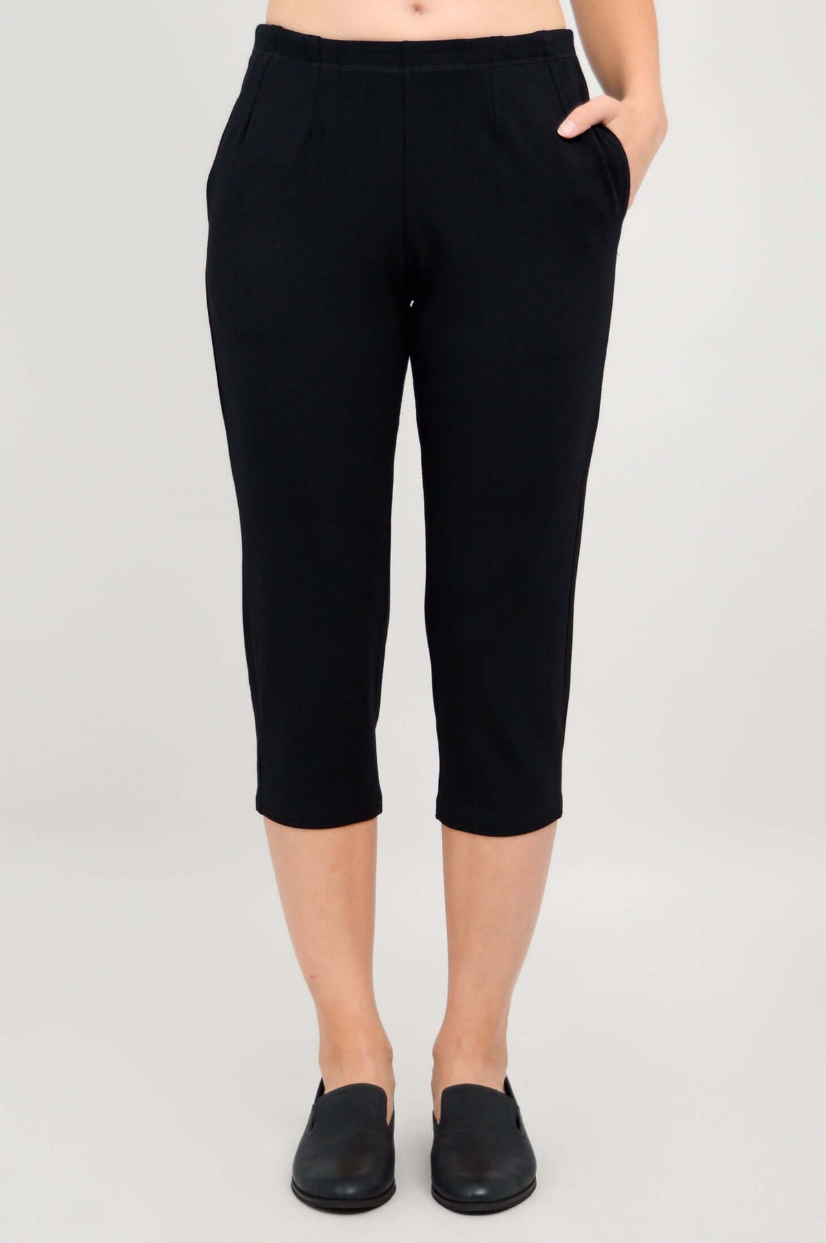 Close-up of Susan Capri black pants with hands in pockets, front view