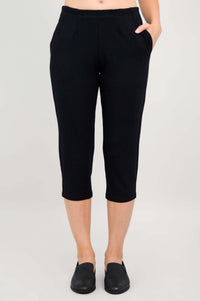 Close-up of Susan Capri black pants with hands in pockets, front view