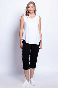 Model wearing Susan Capri black pants and white tank, relaxed front pose