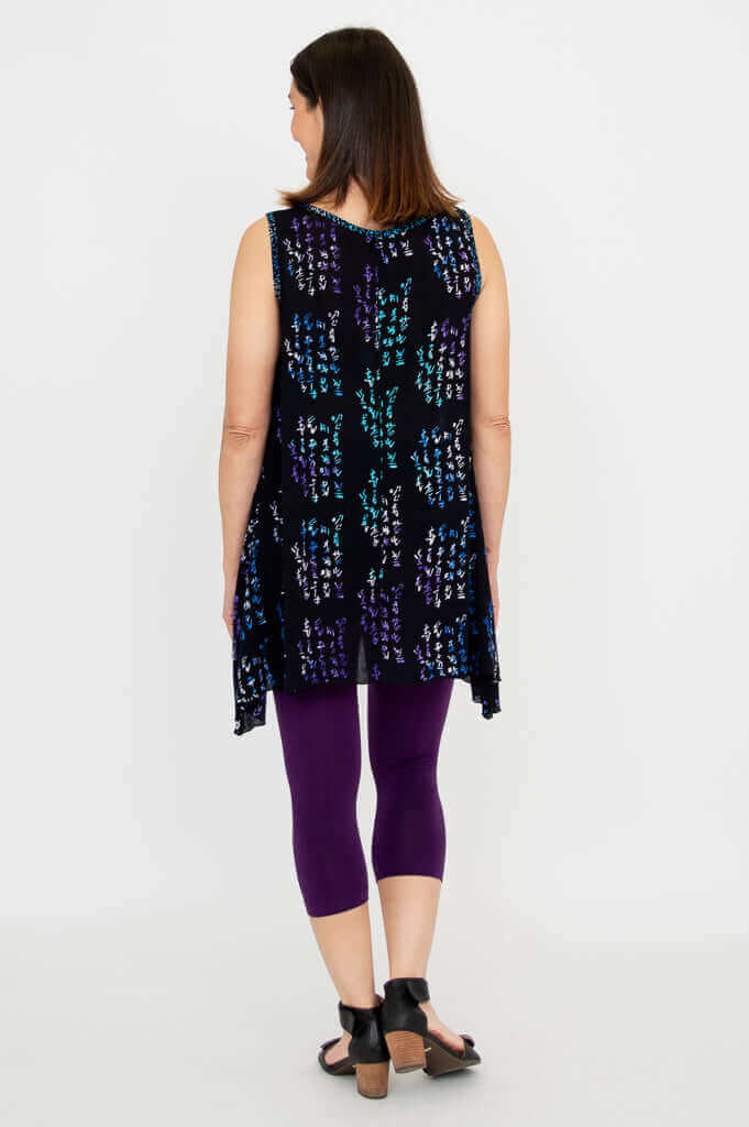 Back view of woman in Swing Tank Midnight Script showing elongated sides and A-line fit