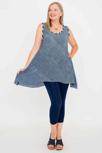 Woman twirling in navy and white striped swing tank, showing the flowy A-line shape
