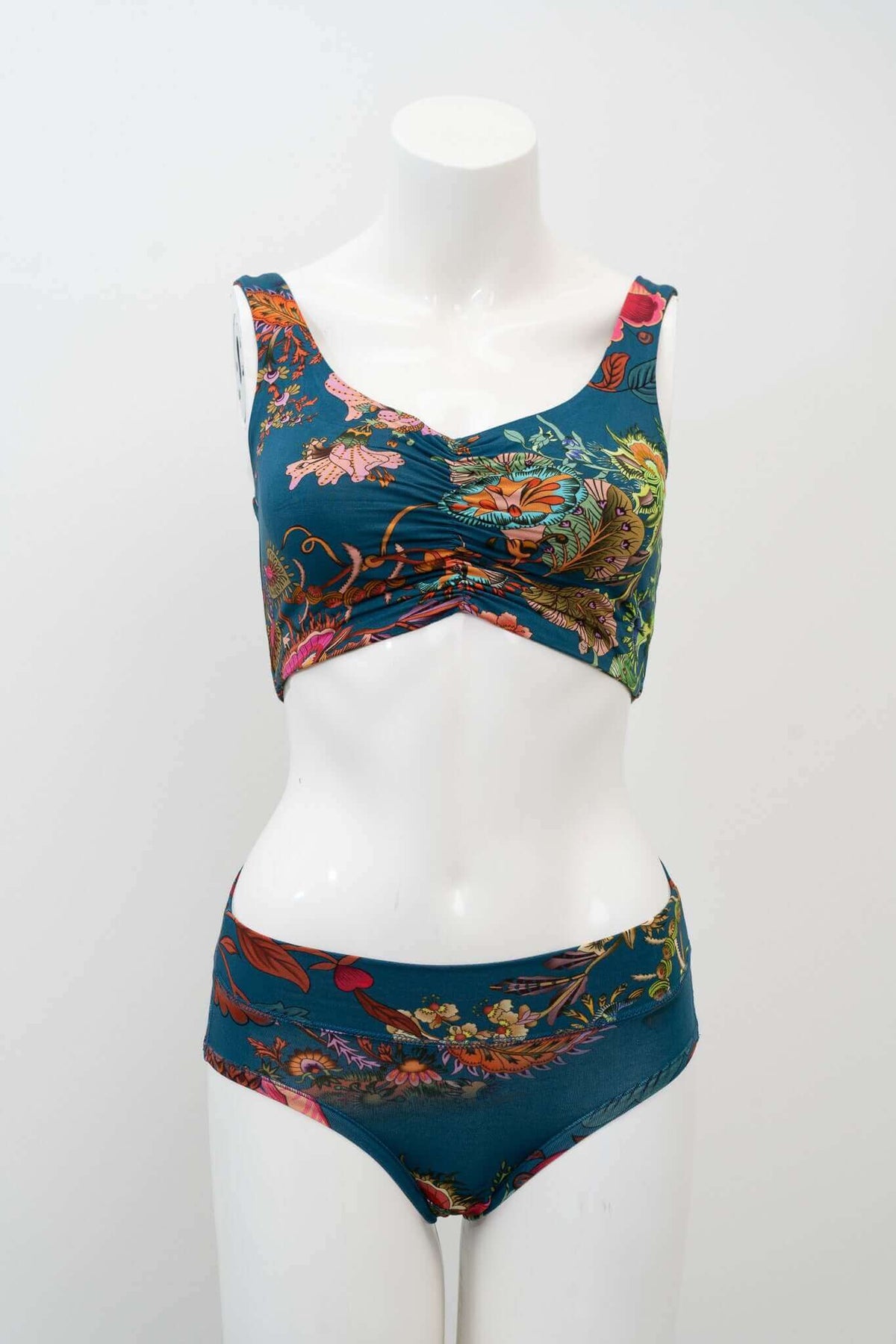 Teal floral crop top and matching bottoms on mannequin, slightly angled front view