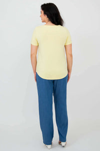 Back view of woman modeling the Tessa Tee in butter yellow