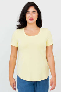 Front view of woman wearing Tessa Tee in butter yellow with scoop neck and short sleeves