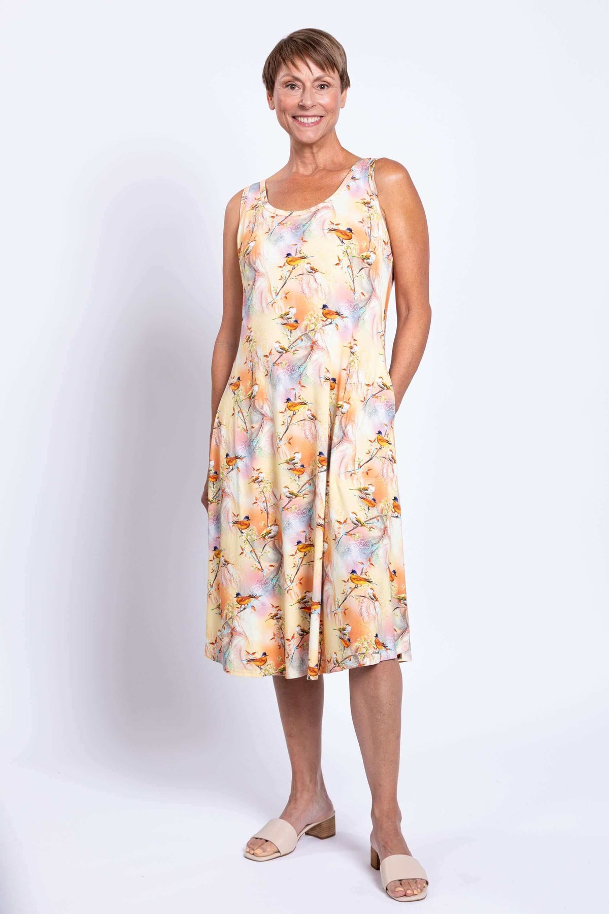 Three-quarter front view of woman in Birds of Paradise bamboo tank dress