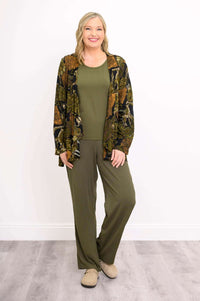 Woman modeling Toucan Jacket with flowy hemline, wearing matching green ensemble