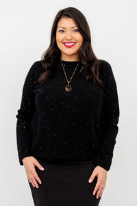 Close up portrait of a smiling woman wearing a sparkly black wool cashmere scoop neck sweater.