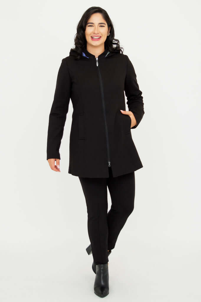 Model walking forward wearing The Highlands Coat fully zipped with hand in pocket