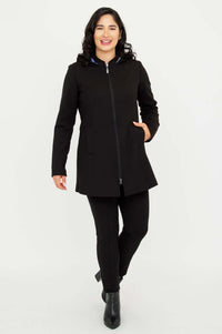 Model walking forward wearing The Highlands Coat fully zipped with hand in pocket