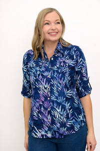 Front view of woman wearing a blue floral patterned blouse and jeans