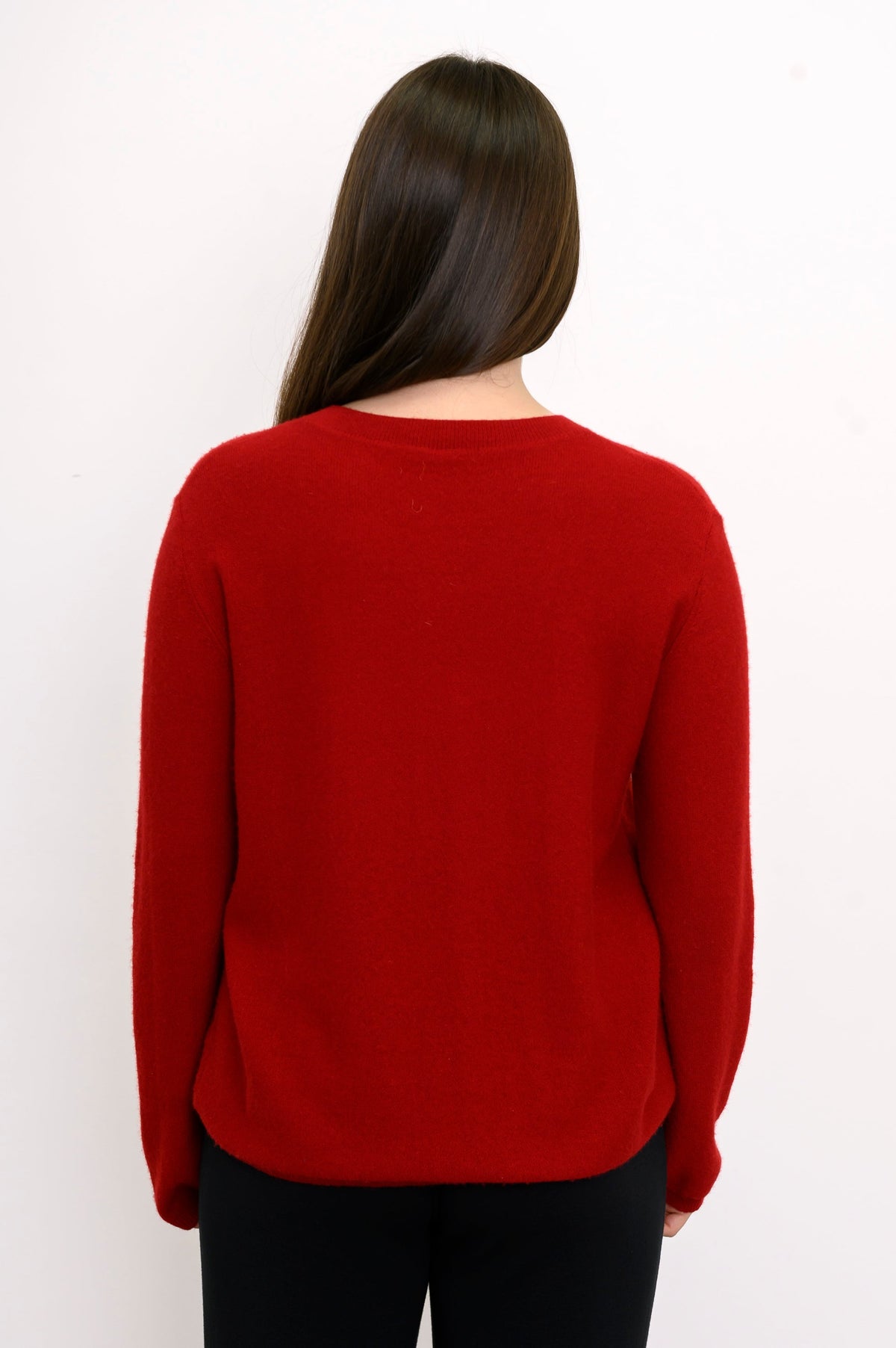 Close-up back view of woman wearing relaxed fit red cashmere sweater