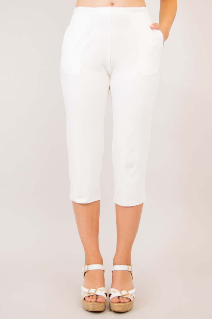 White Susan Capri pants displayed from the front, styled with summer sandals