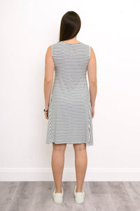 Back view of a woman wearing the Willow Dress in white and black small stripe bamboo fabric showing the knee-length hem.