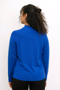 Rear view of a long sleeve cobalt blue fine wool knit sweater showing clean back fit and ribbed hem.