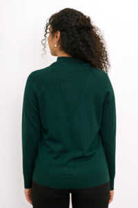 Back view of a woman wearing a hip length deep forest green merino wool button up cardigan in studio.