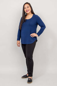 Side view of woman modelling a navy blue long-sleeve shirt and black slim fit pants